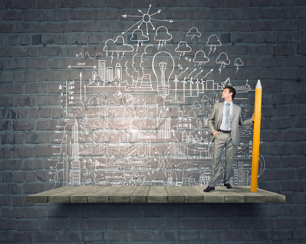 Young businesswoman writing marketing strategy concept with huge pencil